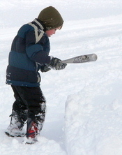 boy hitting drift with baseball bat