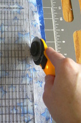 fabric being cut with rotary cutter