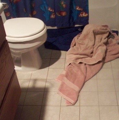 towels lying on floor in bathroom