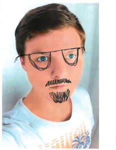 boy looking at camera, glasses and mustache drawn on face
