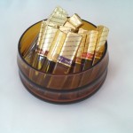 amber colored candy bowl holding Merci chocolates