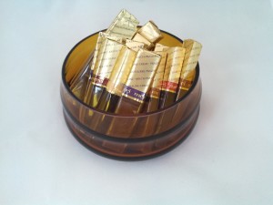 amber colored candy bowl holding Merci chocolates