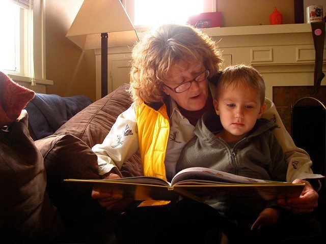 mom reading book to son