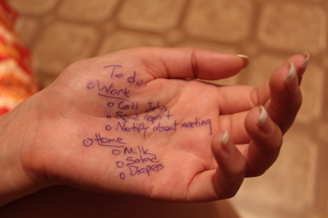 woman's hand with todo list written on it