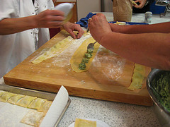 2 people's hands making ravioli