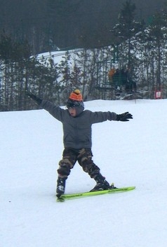 boy skiing down hill