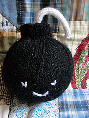 crocheted black bomb with smiley face on it