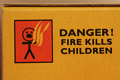 side of match box with warning 'fire kills children'