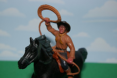 plastic cowboy on plastic horse throwing lasso
