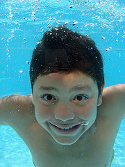boy grinning at camera underwater