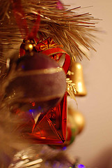 gold and red christmas ornaments hanging on tree