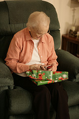 older woman opening Christmas gift