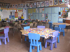 kindergarten classroom with tables, chairs, educational materials