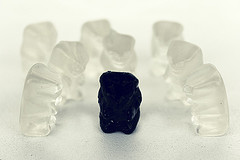 black gummy candy surrounded by clear candies