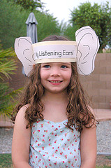 girl with large paper ears titled "listening ears"
