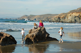 kids playing at ocean's eadge
