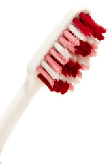 white toothbrush with red and pink bristles