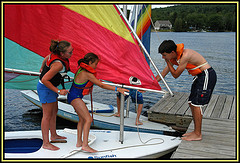kids climbing on to a sailboat