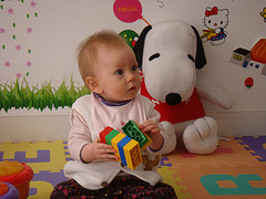 baby in playroom holding toy
