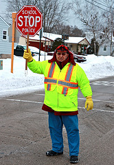 crossing guard holding up stop sign