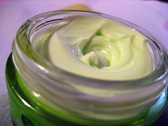 small tub of greenish skin cream