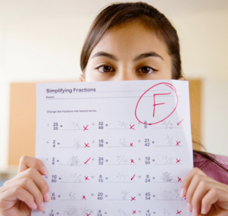 girl holding test with failing grade