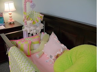 crib with pink and green decorations