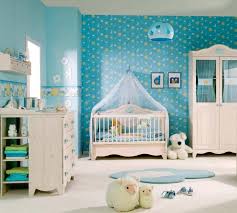nursery with white furniture, blue walls