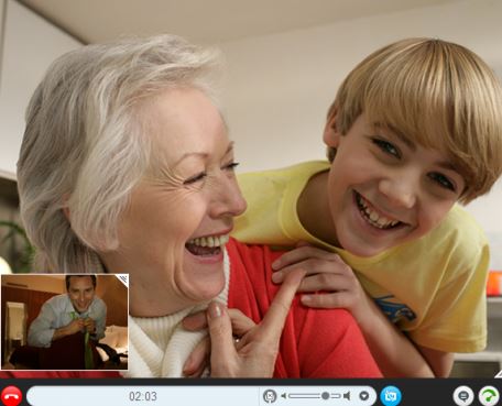 boy leaning over grandma's shoulder, both are laughing
