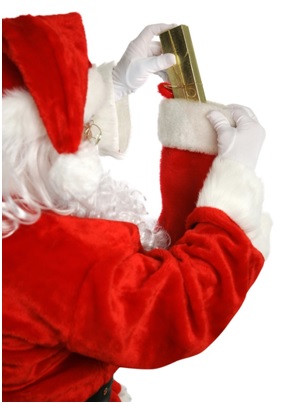 Santa Claus putting gift into stocking