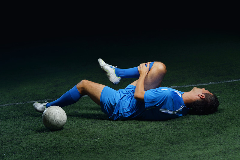 athlete laying on ground stretching