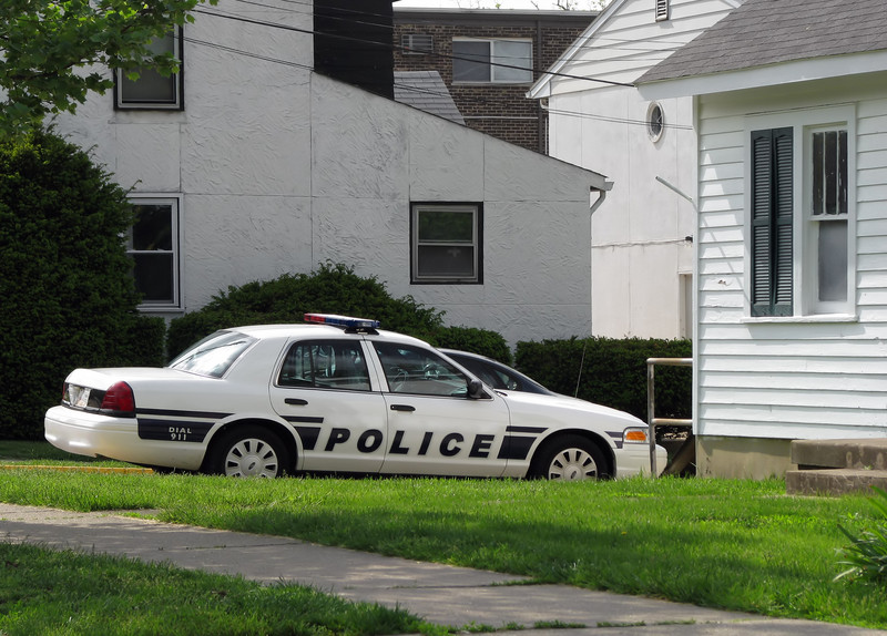 police car parked in front of house