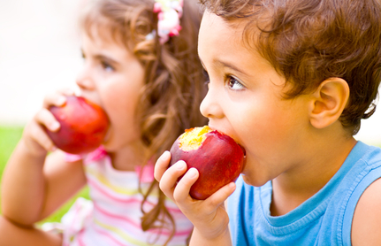 boy and girl eating apples