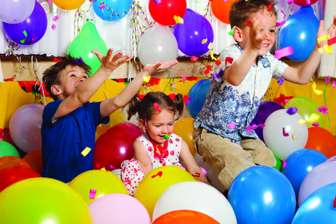 children jumping in a lot of balloons