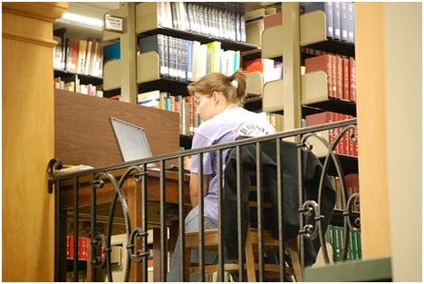 girl studying at computer in library