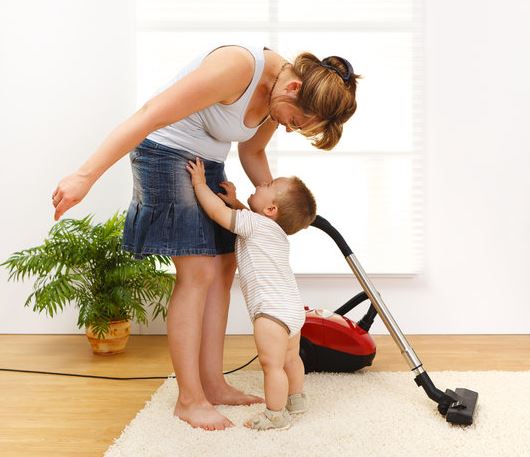 toddler helping mom vacuum