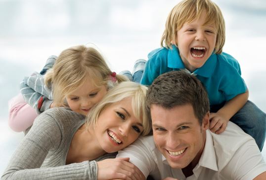 parents and two children laughing together